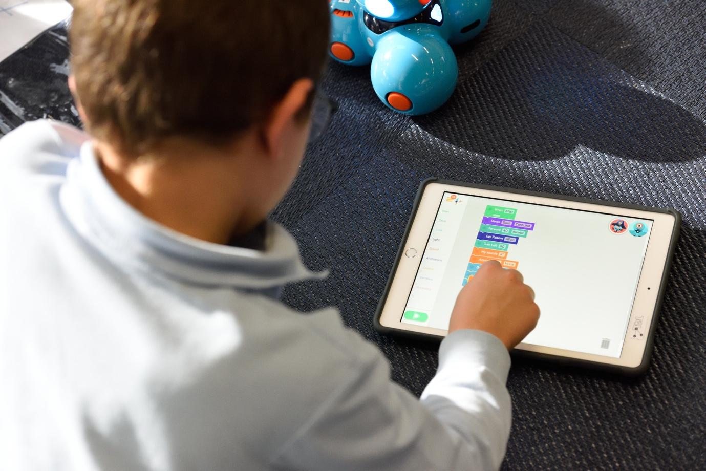 A child using a tablet Description automatically generated with medium confidence